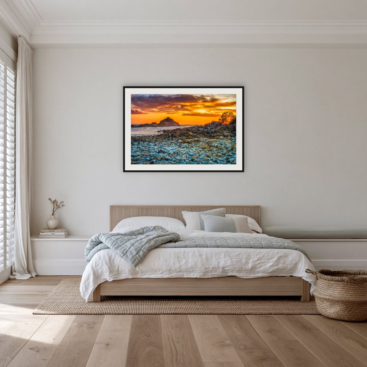 Mimosa Rocks Sunrise framed print in black with a white mat, in a bedroom