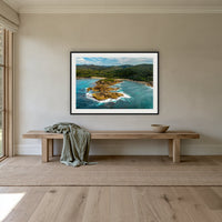 Mimosa Rocks framed print in black with a white mat, above an oak bench in a hallway