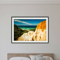 The Pinnacles framed print in black with a white mat, in a bedroom
