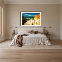 The Pinnacles framed print in black with a white mat, above an ivory linen bed in a bedroom