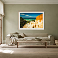 The Pinnacles framed print in oak with a white mat, above a linen sofa against a sage wall in a lounge room