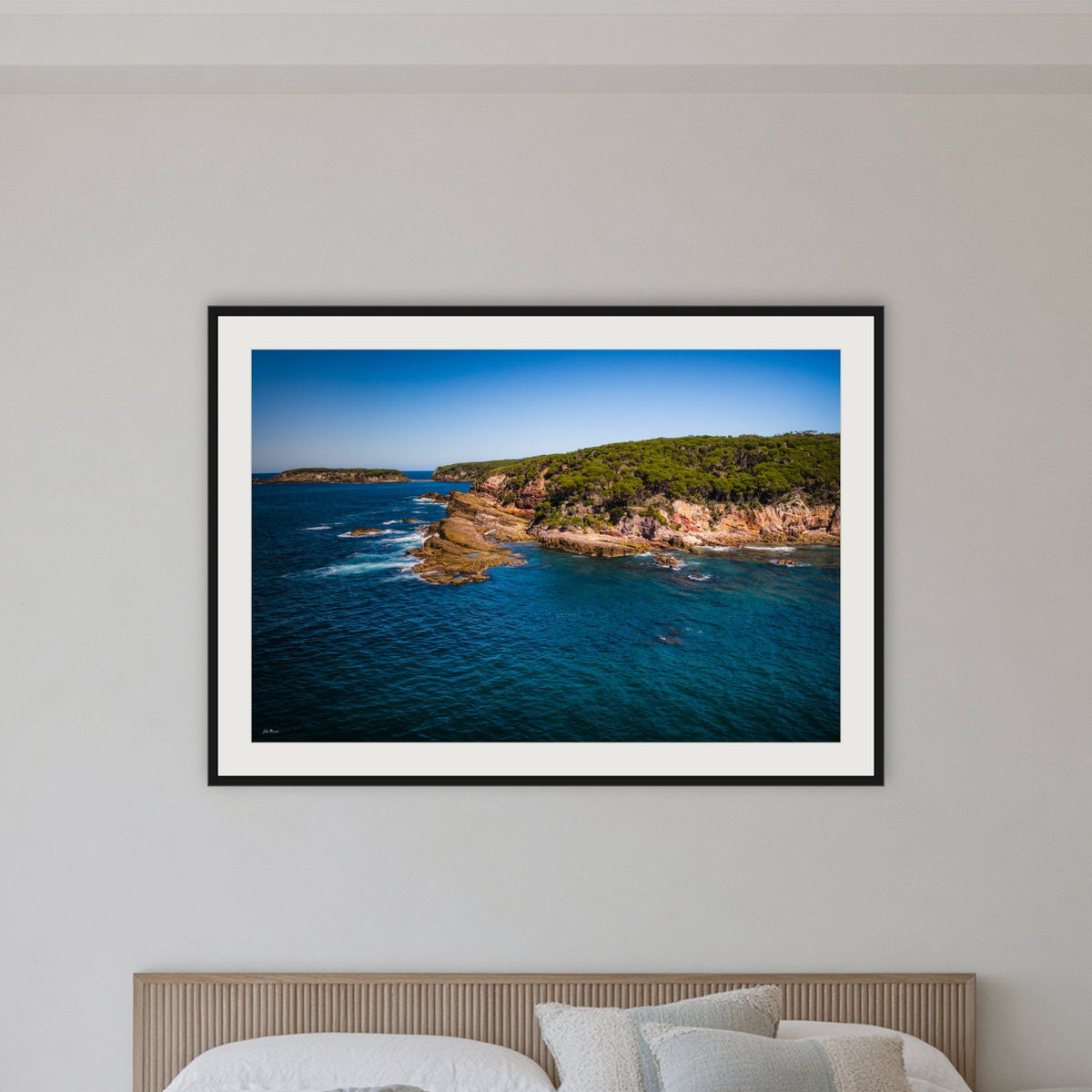 Terrace Beach framed print in black with a white mat, in a bedroom