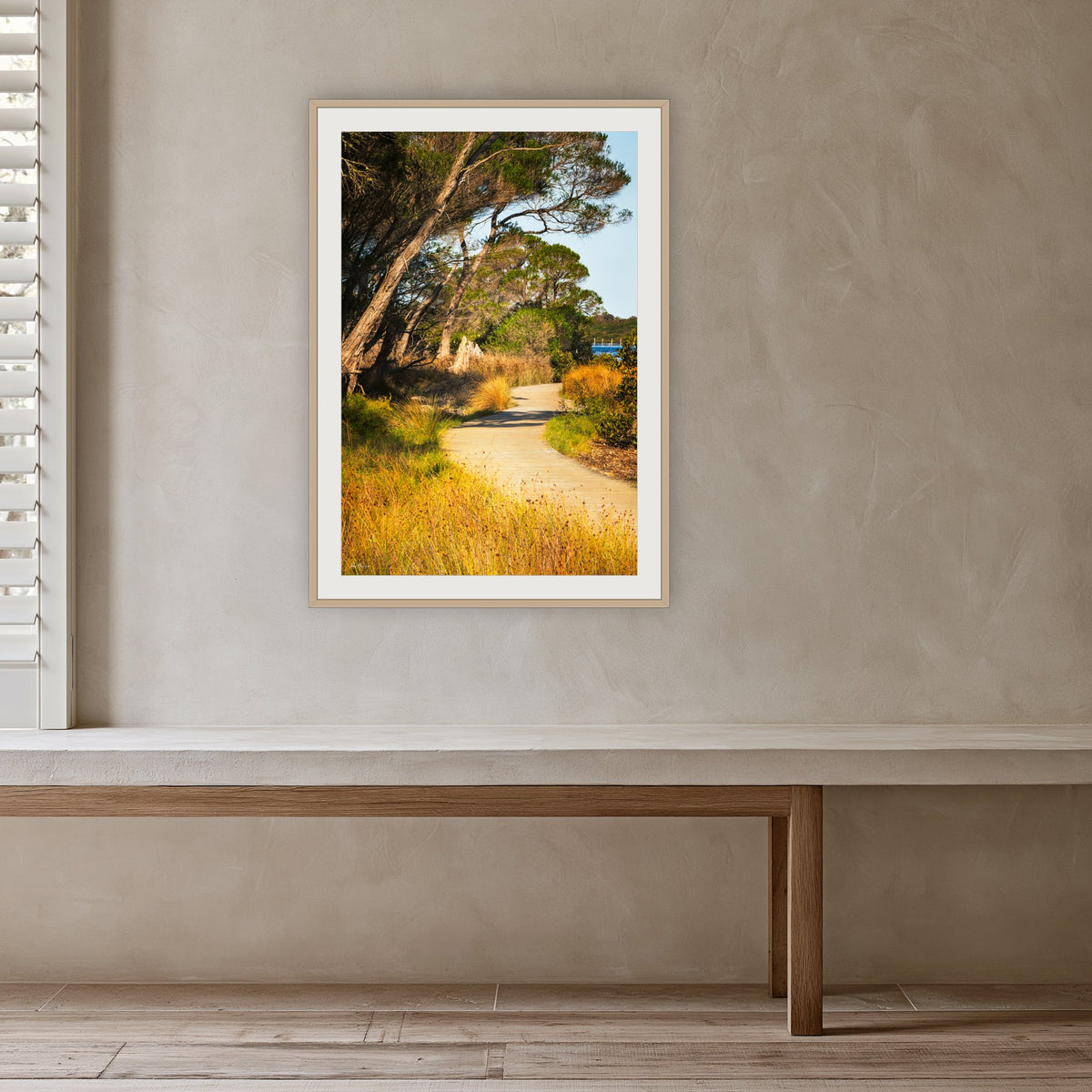 Merimbula Boardwalk Three framed print in oak with a white mat, in a plaster-walled hallway