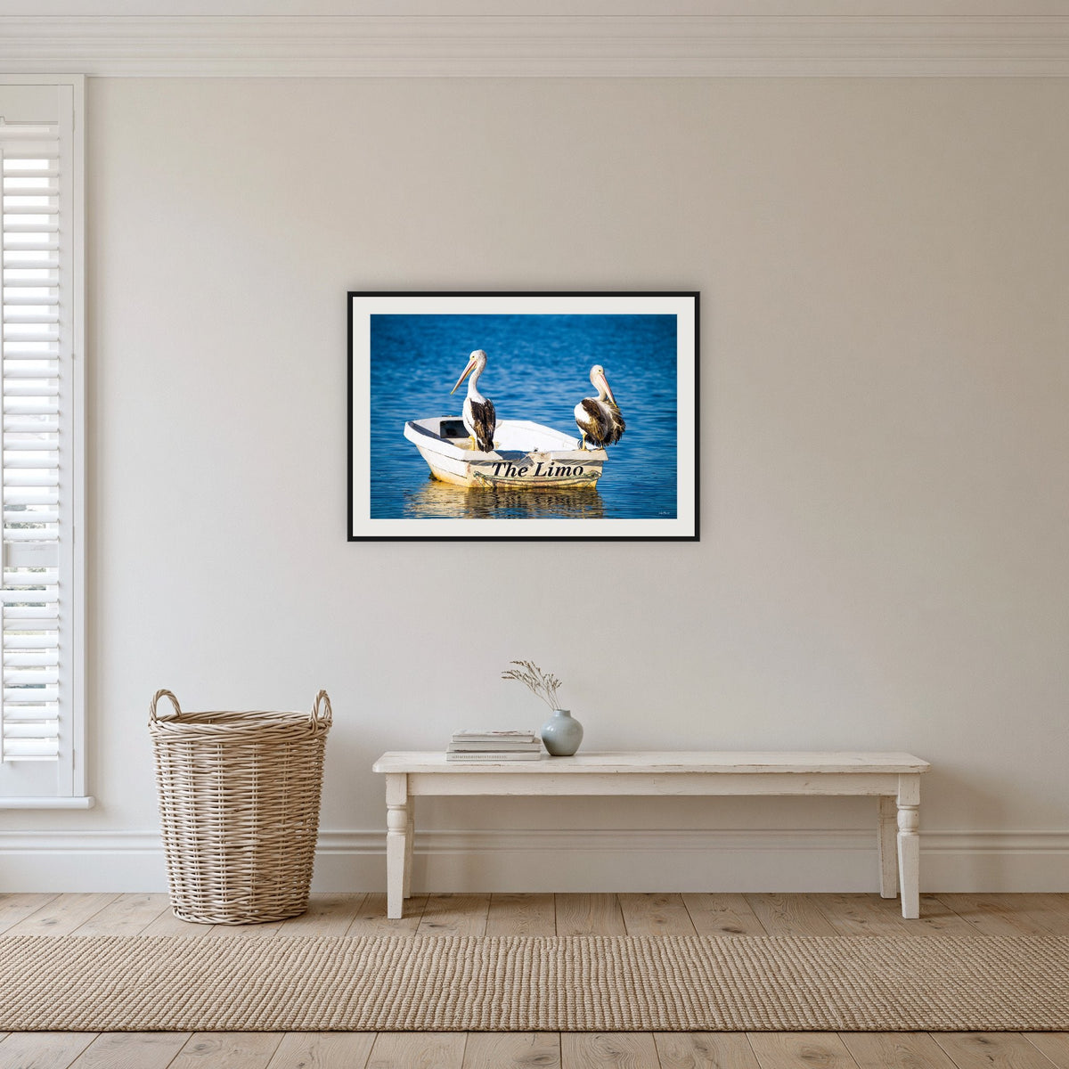 Pelican's Limo framed print in black with a white mat, in a hallway