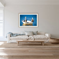 Pelican's Limo framed print in oak with a white mat, in a lounge room