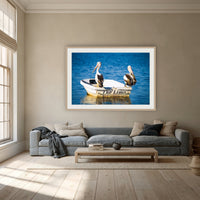 Pelican's Limo framed print in oak with a white mat, above a dusty blue linen sofa in a lounge room
