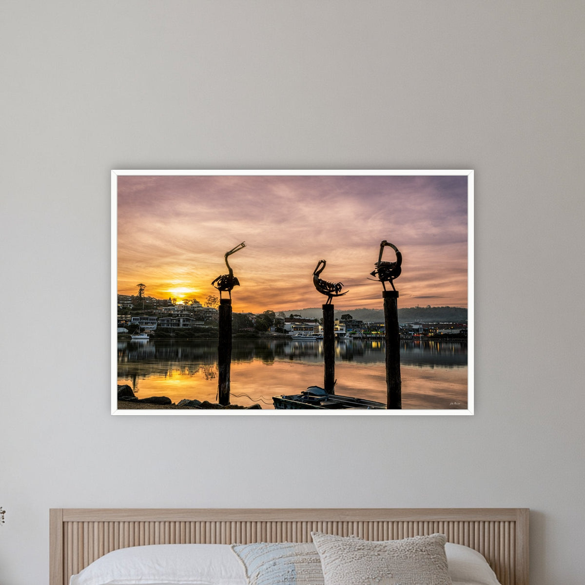 Pelican Sculptures in a white frame without a mat, on a coastal bedroom wall
