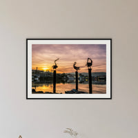 Pelican Sculptures framed print in black with a white mat, in a hallway
