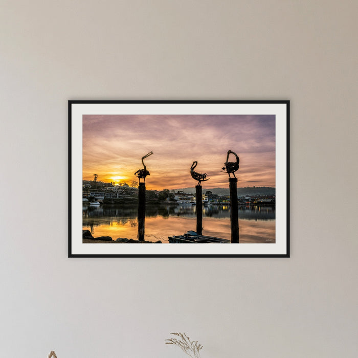 Pelican Sculptures framed print in black with a white mat, in a hallway