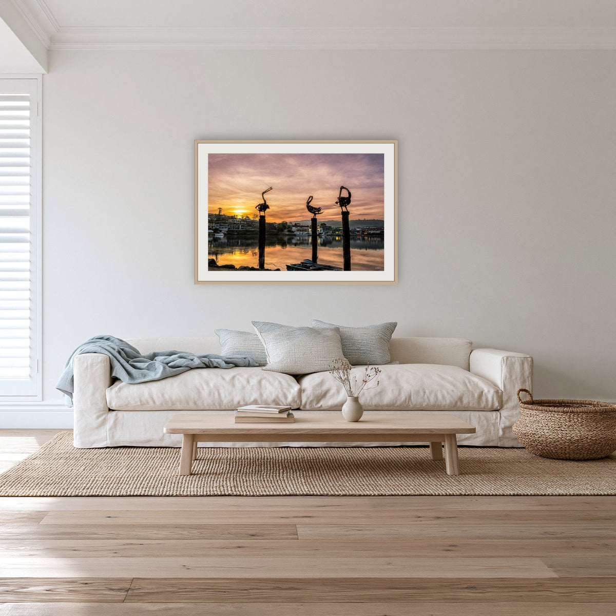 Pelican Sculptures framed print in oak with a white mat, in a lounge room