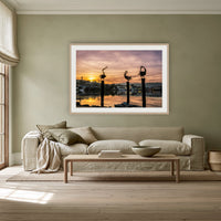 Pelican Sculptures framed print in oak with a white mat, above a linen sofa against a sage wall in a lounge room