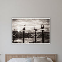 Pelican Sculptures in black and white in a white frame without a mat, on a coastal bedroom wall