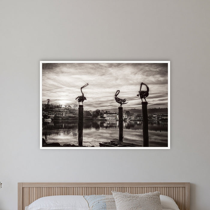 Pelican Sculptures in black and white in a white frame without a mat, on a coastal bedroom wall