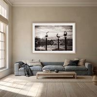 Pelican Sculptures in black and white framed print in oak with a white mat, above a dusty blue linen sofa in a lounge room