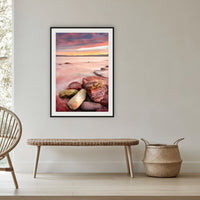 Sunset from Merimbula Wharf framed print in black with a white mat, in a cane-panelled hallway