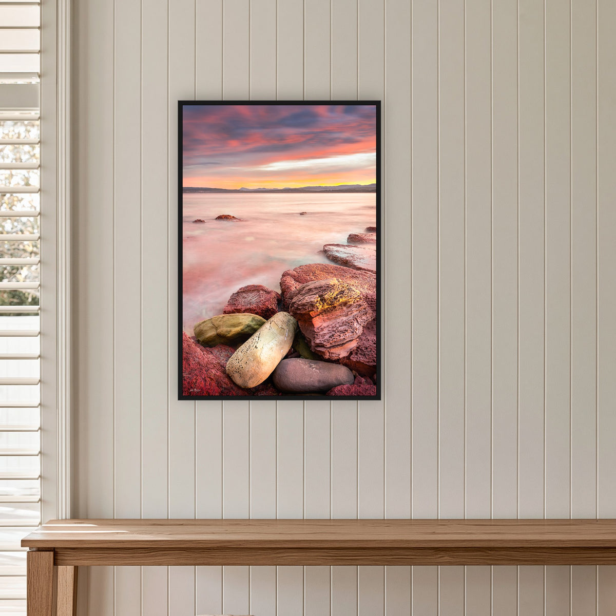Sunset from Merimbula Wharf in a black frame without a mat, on a panelled hallway wall