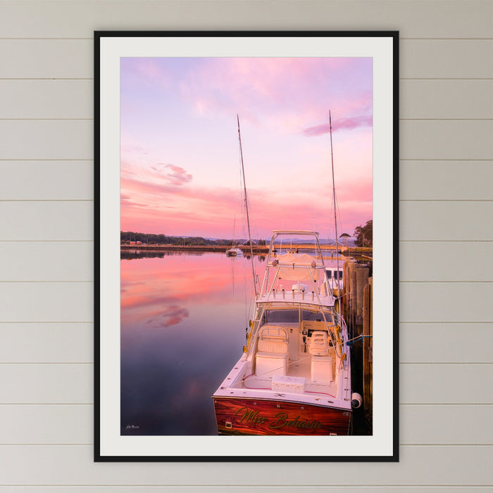 Miss Behavin framed print in black with a white mat, in a coastal bedroom