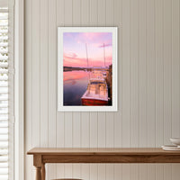 Miss Behavin framed print in white with a mat, on a panelled hallway wall