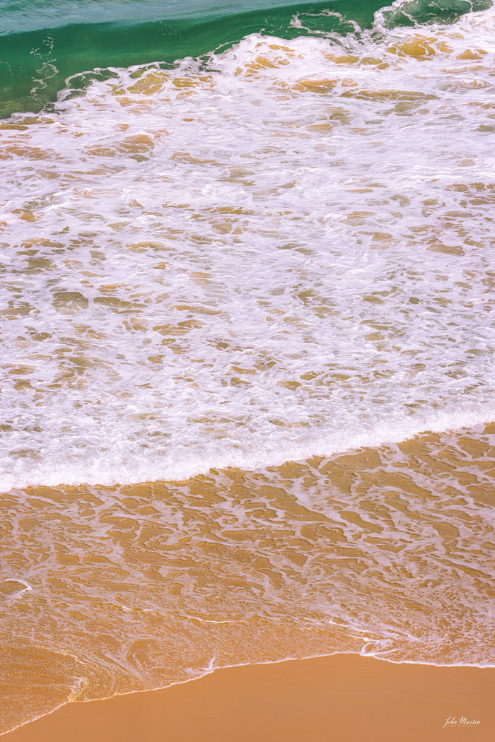 A wave running up the golden sand as white foam, turquoise water beyond, Tura Beach Headland — fine art print