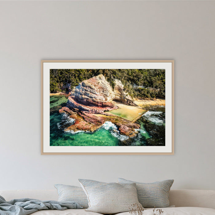 Aslings Beach Rock Pool framed print in oak with a white mat, in a lounge room