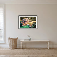 Aslings Beach Rock Pool framed print in black with a white mat, in a hallway