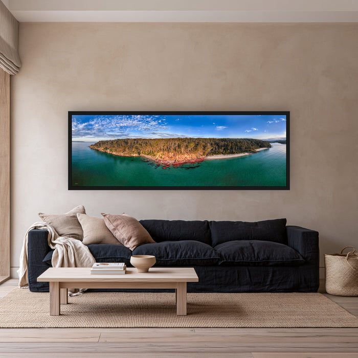 Barmouth Beach Pambula super wide panorama in a black frame above a navy linen sofa — wall art, Sapphire Coast NSW