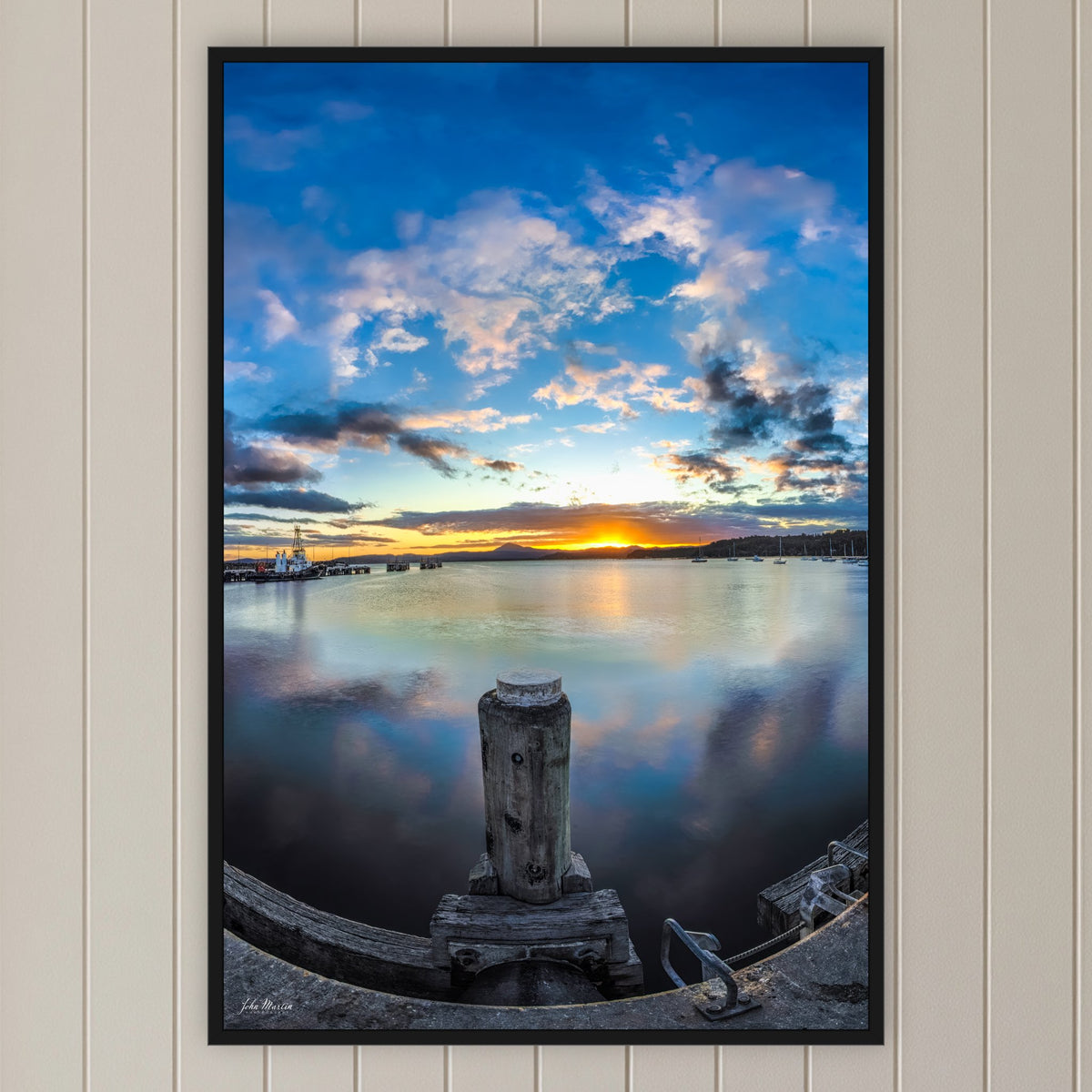 Eden Wharf Sunset in a black frame without a mat, on a panelled hallway wall