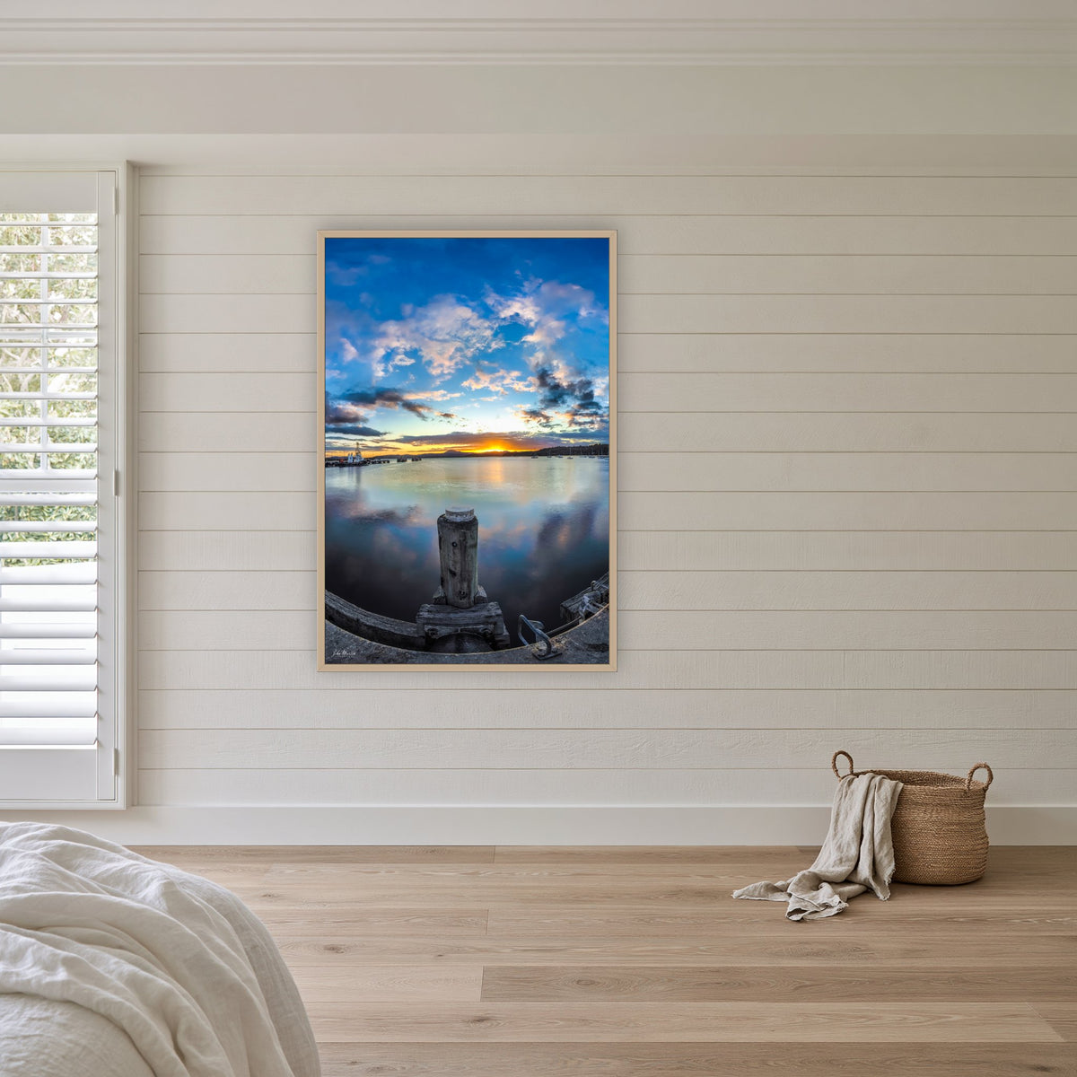Eden Wharf Sunset in an oak frame without a mat, above the bed in a white coastal bedroom