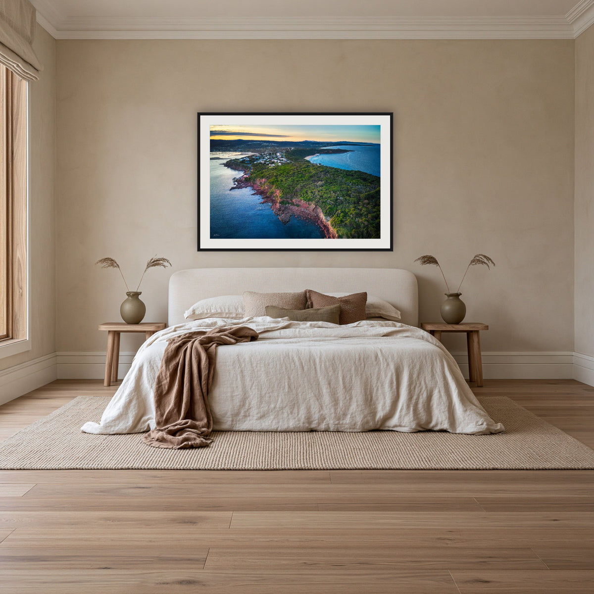 Long Point framed print in black with a white mat, above an ivory linen bed in a bedroom
