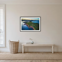 Long Point framed print in black with a white mat, in a hallway