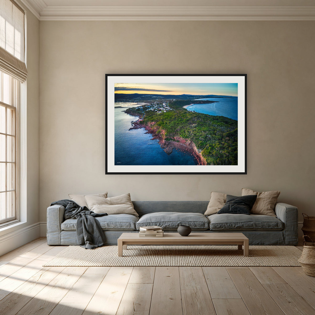Long Point framed print in black with a white mat, above a dusty blue linen sofa in a lounge room
