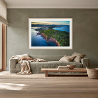 Long Point framed print in oak with a white mat, above a sage linen sofa in a lounge room