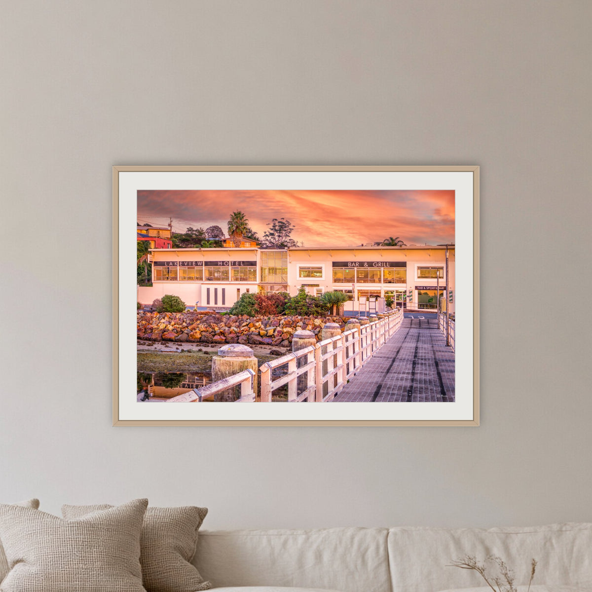 Lakeview Hotel framed print in oak with a white mat, in a lounge room