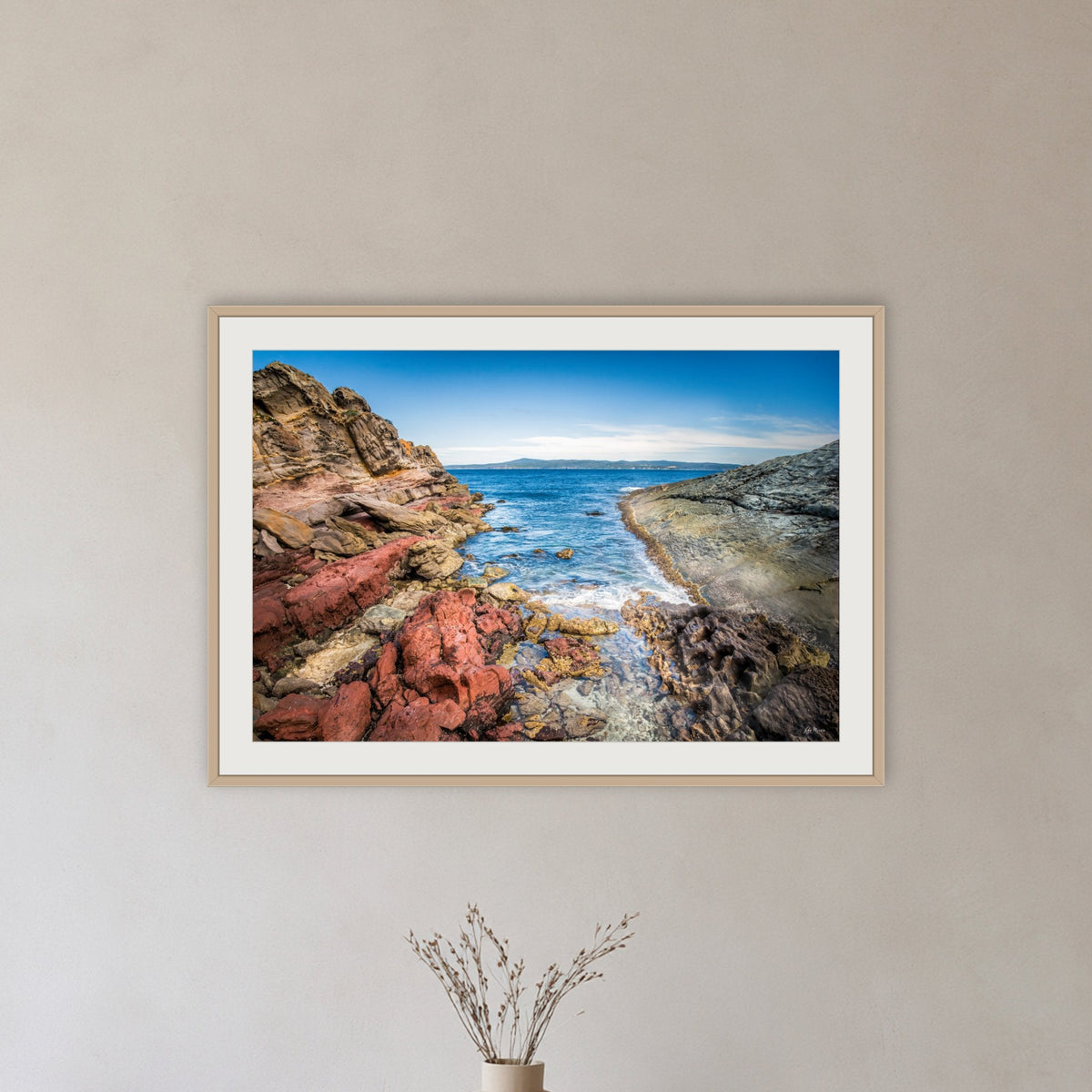 North Head Worang Point framed print in oak with a white mat, in a hallway