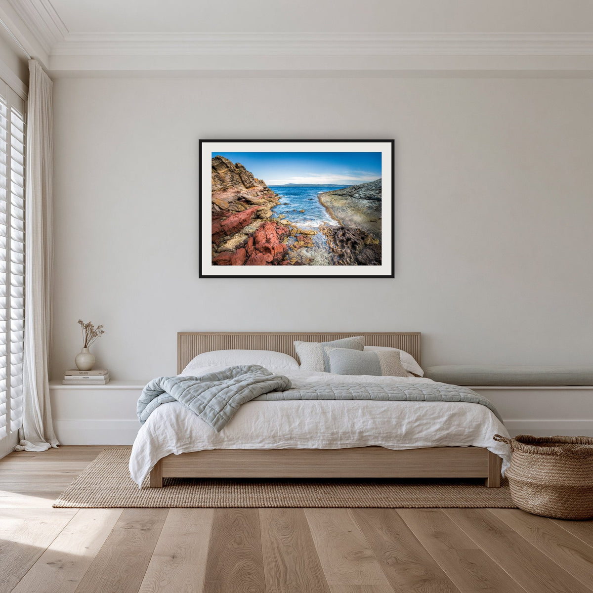 North Head Worang Point framed print in black with a white mat, in a bedroom