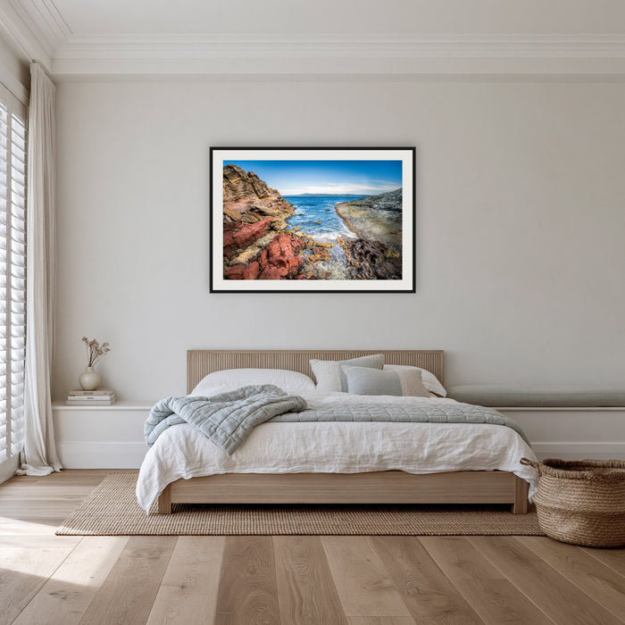 North Head Worang Point framed print in black with a white mat, in a bedroom