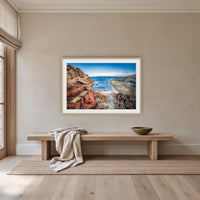 North Head Worang Point framed print in oak with a white mat, above an oak bench in a hallway