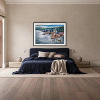 North Head Worang Point framed print in black with a white mat, above a navy linen bed in a bedroom