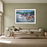 North Head Worang Point Headland framed print in oak with a white mat, above a linen sofa against a sage wall in a lounge room