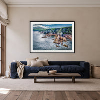 North Head Worang Point Headland framed print in black with a white mat, above a navy linen sofa in a lounge room