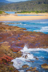 Surf breaking over red rock shelves at Short Point, the beach and the back lake beyond, Merimbula — fine art print