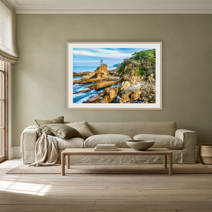 Lone Tree at Cuttagee framed print in oak with a white mat, above a linen sofa against a sage wall in a lounge room