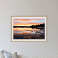 Top Lake Sunset framed print in oak with a white mat, in a lounge room