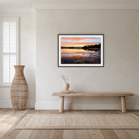Top Lake Sunset framed print in black with a white mat, in a hallway