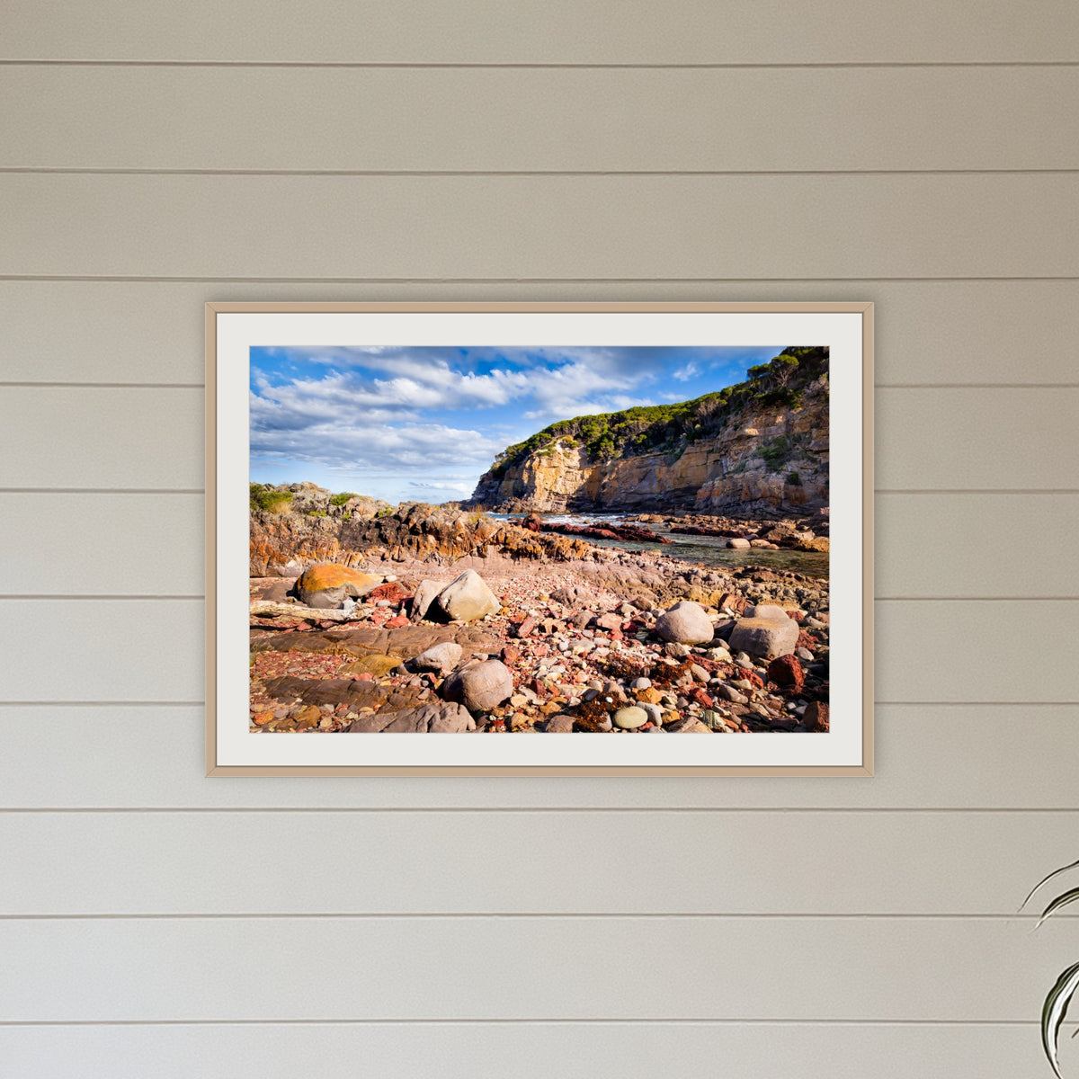 Lennards Island framed print in oak with a white mat, hanging in a coastal lounge room