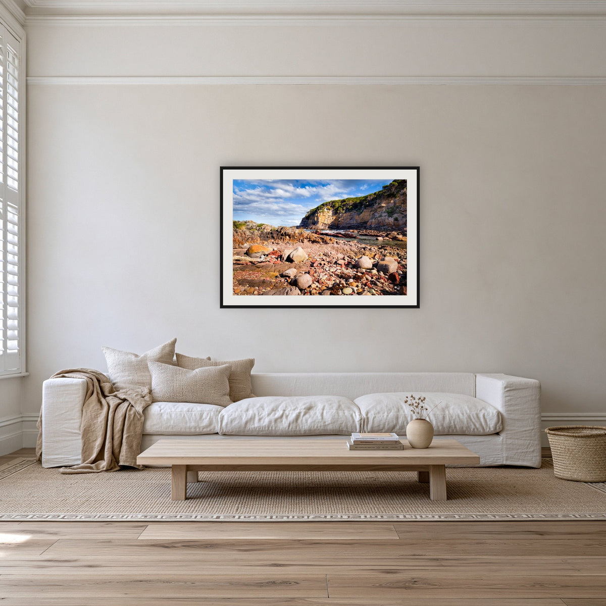 Lennards Island framed print in black with a white mat on a lounge room wall
