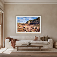 Lennards Island framed print in oak with a white mat, above an oatmeal linen sofa in a lounge room