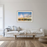 Rainbow over Merimbula Lake framed print in oak with a white mat, in a lounge room