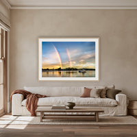 Rainbow over Merimbula Lake framed print in oak with a white mat, above an oatmeal linen sofa in a lounge room