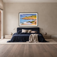 Short Point Cliffs framed print in black with a white mat, above a navy linen bed in a bedroom